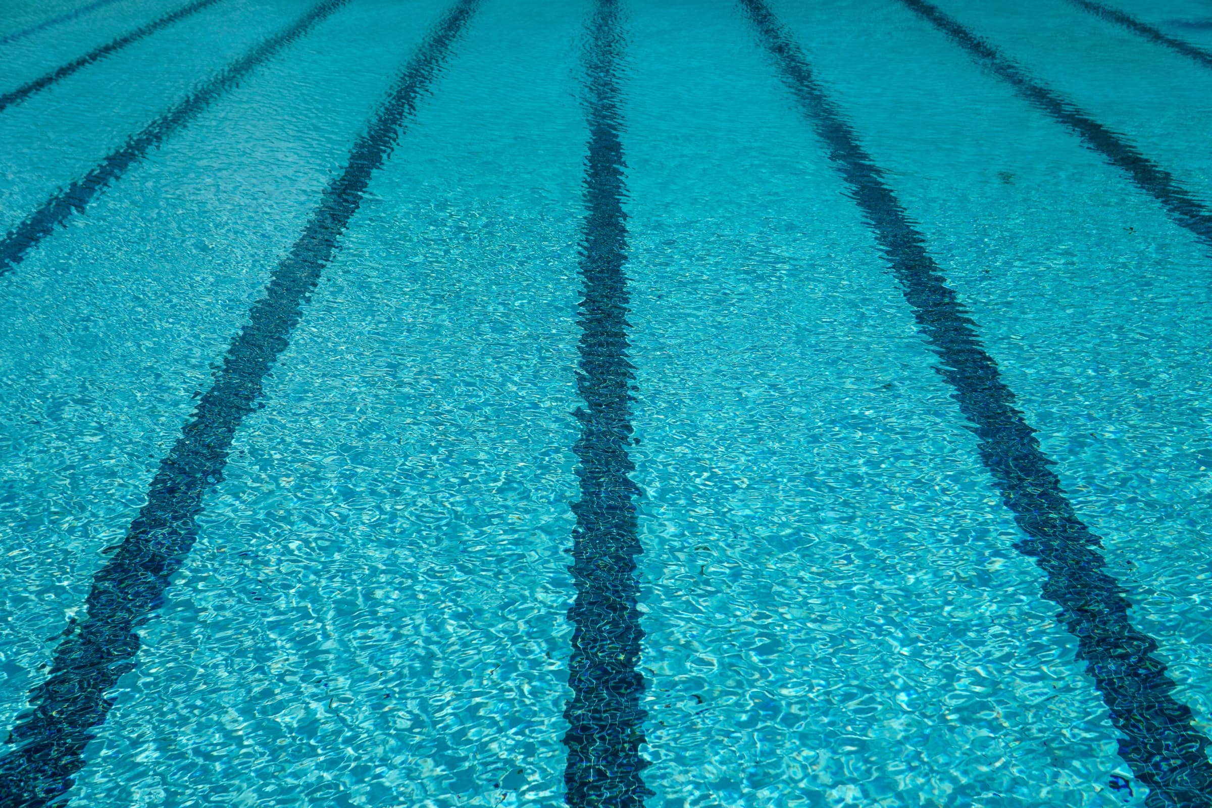 Clear aqua water over swimming pool lanes