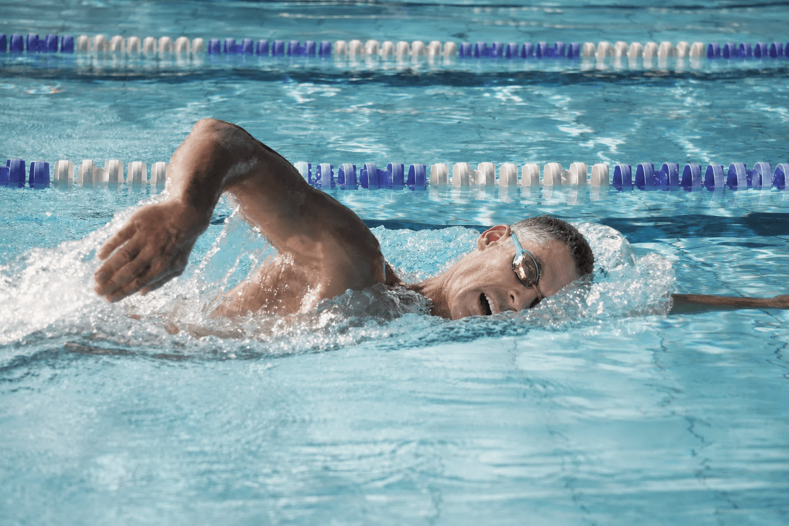 Adult swimmer building freestyle fitness and endurance in the pool