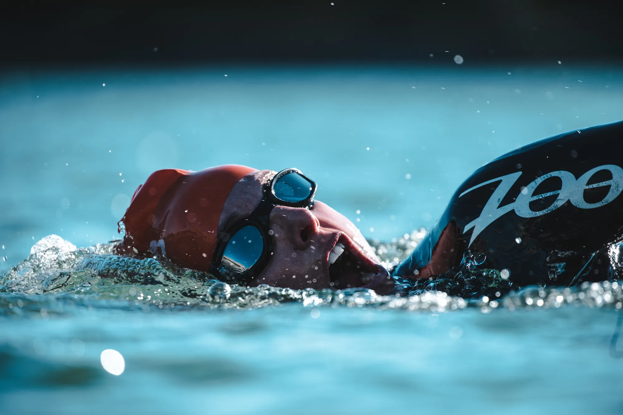 Freestyle swimmer racing at speed in a pool